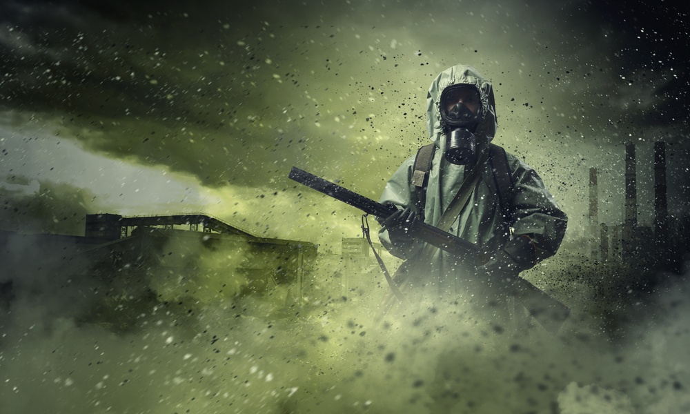 Man In Gas Mask And Camouflage Holding Gun Disaster Concept